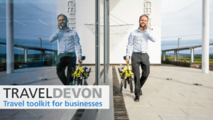 Man walking and holding a folding bike